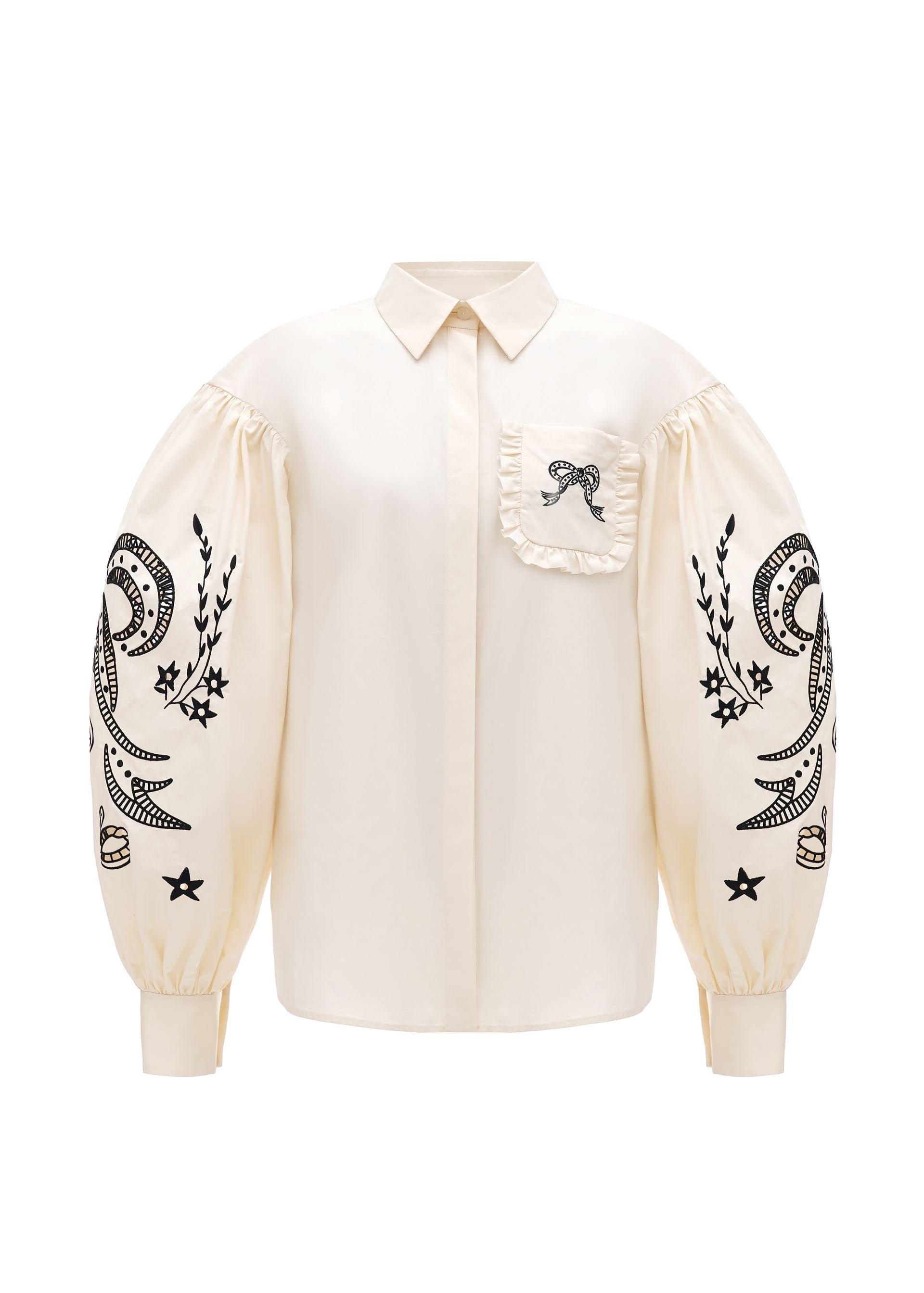 White blouse with black embroidery on sleeves against a white background