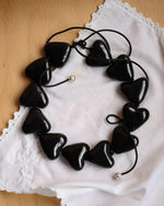Load image into Gallery viewer, AURA necklace with black porcelain hearts
